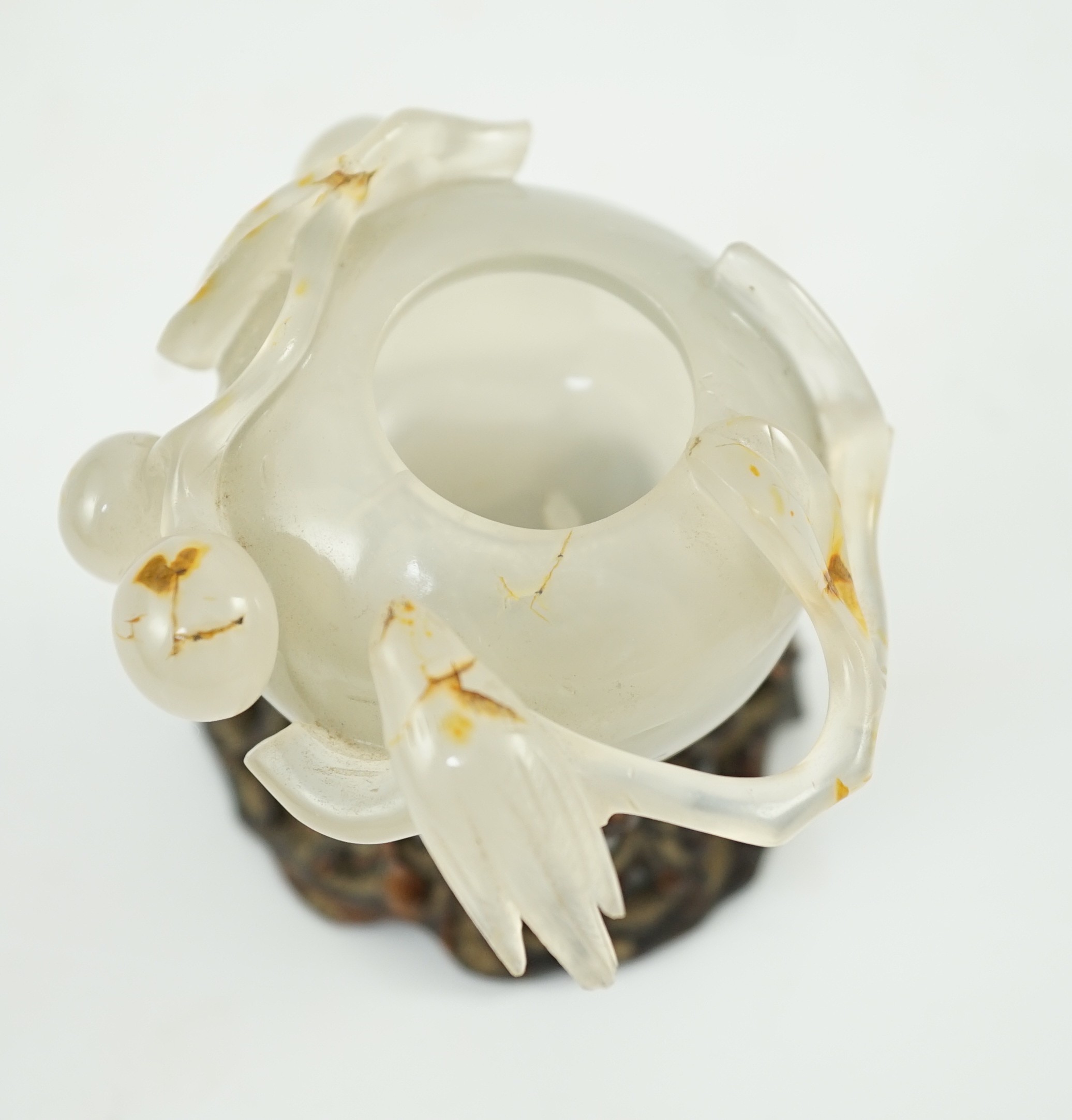 A Chinese small carved agate brushwasher on wooden stand, 19th century, 8.5cm high including stand